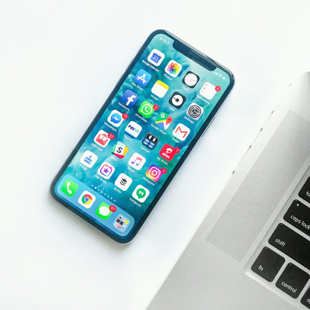 Photo of an unlocked iPhone sitting on a desk tabletop. 